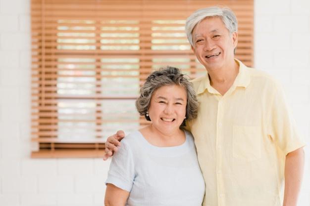 asian elderly couple feeling happy smiling looking camera while relax living room home 7861 1562
