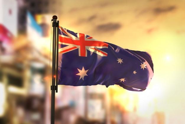 australia flag against city blurred background sunrise backlight 1379 1610